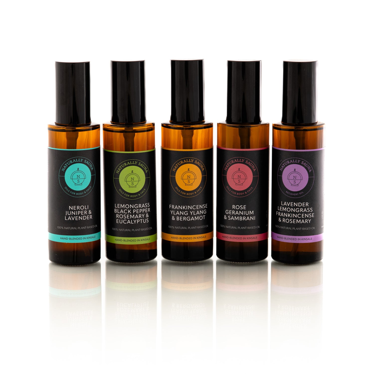 Five Naturally Sauna amber glass bottles with black caps on a white background
